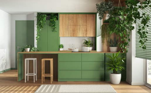 A modern kitchen with light sage green cabinets and light wood countertops.